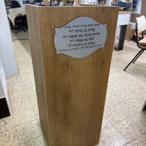 עמדת הנחת תפילין מעץ אלון עם שלט הנצחה בצורת מגילה
